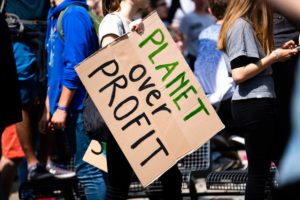 A sign saying "Planet Over Profit"