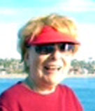Chiwah Slater on Oceanside Pier, with beach and houses behind her.