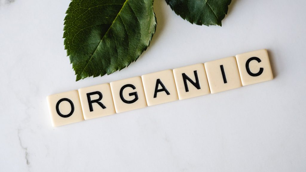 Green leaves and tiles that spell out the word "Organic."