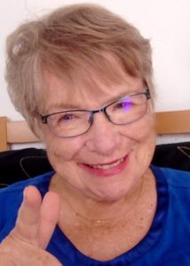 A picture of Chiwah Slater, smiling, pointing a friendly finger at you.